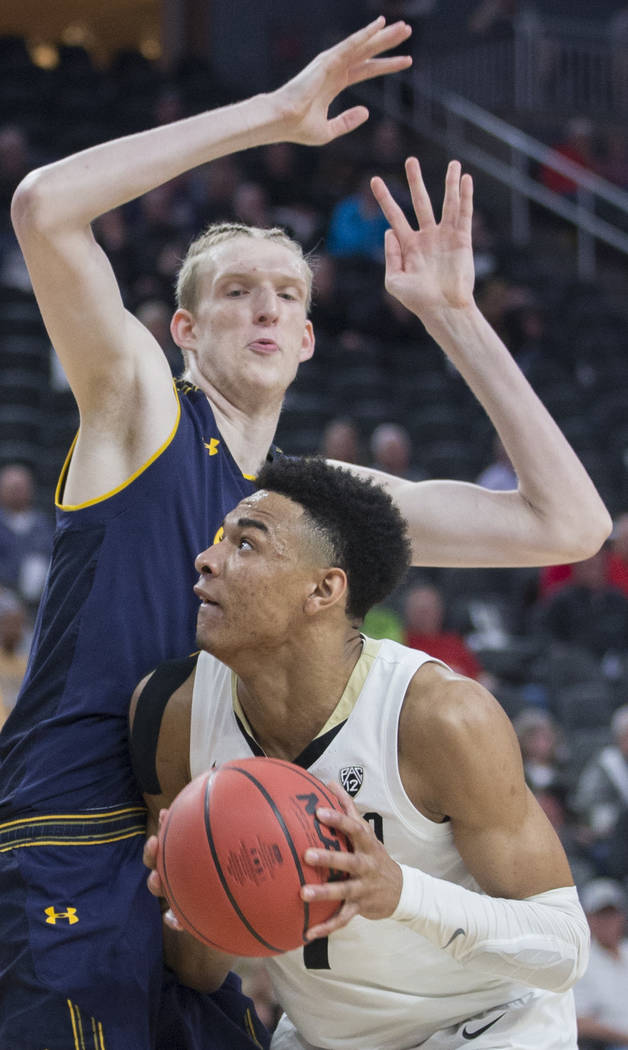 Colorado sophomore guard Tyler Bey (1), a Las Vegas native, fights for position with California freshman center Connor Vanover (23) in the second half during the Pac-12 tournament on Wednesday, Ma ...