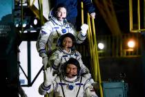 U.S. astronauts Christina Hammock Koch, centre, Nick Hague, above, and Russian cosmonaut Alexey Ovchinin, crew members of the mission to the International Space Station, ISS, wave as they board to ...