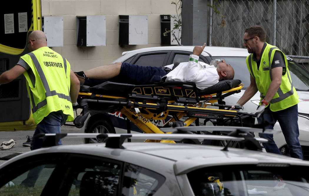 Ambulance staff take a man from outside a mosque in central Christchurch, New Zealand, Friday, March 15, 2019. (AP Photo/Mark Baker)