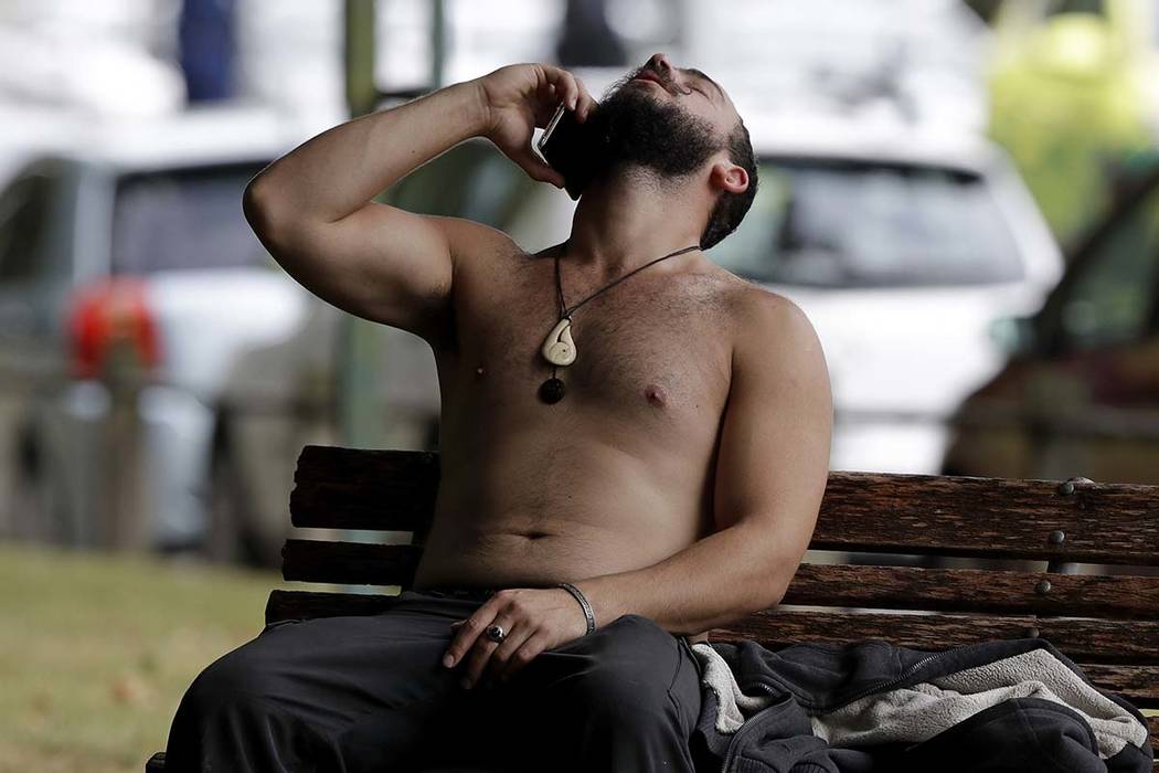 A man reacts as he speaks on a mobile phone outside a mosque in central Christchurch, New Zealand, Friday, March 15, 2019. A witness says many people have been killed in a mass shooting at a mosqu ...