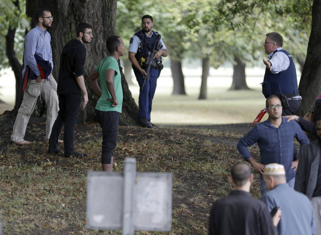 Police attempt to move people away from outside a mosque in central Christchurch, New Zealand, Friday, March 15, 2019. Many people were killed in a mass shooting at a mosque in the New Zealand cit ...