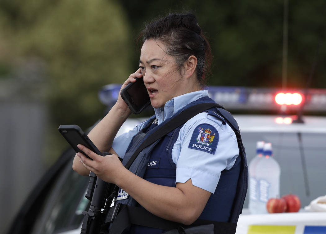 A police officer talks on her phone as a roadblock near a mass shooting at a mosque in Linwood, Christchurch, New Zealand, Friday, March 15, 2019. Multiple people were killed during shootings at t ...