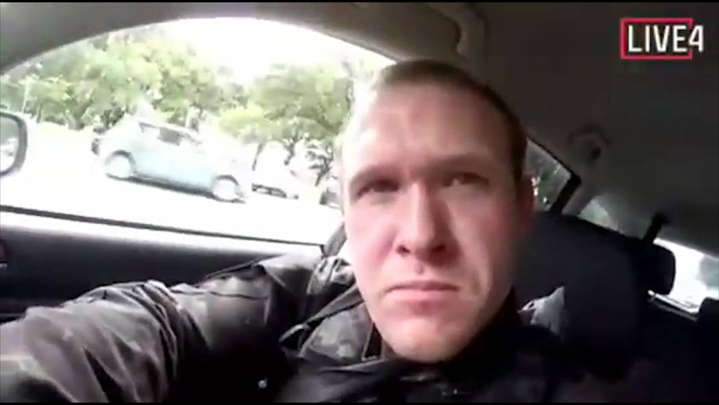 This image taken from the alleged shooter’s video, which was filmed Friday, March 15, 2019, shows him as he drives and he looks over to three guns on the passenger side of his vehicle in Ne ...