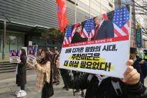 In this March 2, 2019, photo, South Korean protesters with banners showing photos of U.S. President Donald Trump and North Korean leader Kim Jong Un stage a rally to denounce policies of the Unite ...