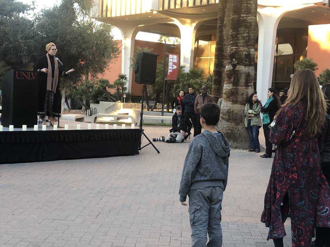 A boy in the crowd watches recent UNLV graduate Lamiya Redzic recite a poem she wrote at a vigil on Friday, March 15, 2019. (Katelyn Newberg/ Las Vegas Review-Journal)