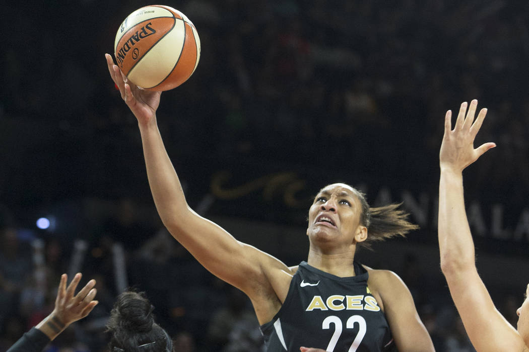 Aces center A'ja Wilson (22) drives past Phoenix Mercury guard Briann January (12) in the first quarter on Wednesday, August, 1, 2018, at the Mandalay Bay Events Center, in Las Vegas. Benjamin Hag ...
