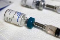 A measles vaccine vial (Vernon Bryant/The Dallas Morning News via AP)