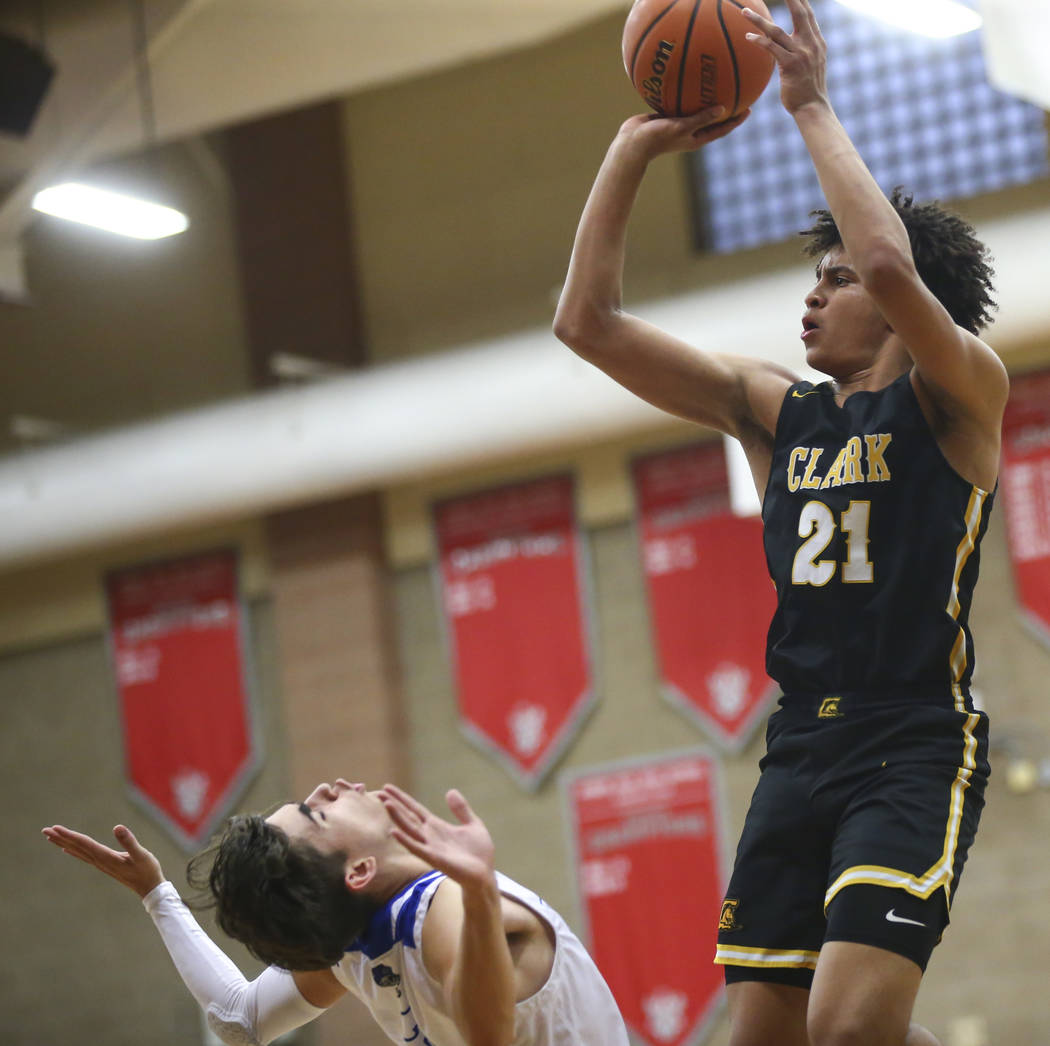 Clark's Jalen Hill (21) shoots over Desert Pines' Milos Uzan (12) during the second half of a Class 4A state boys basketball quarterfinal game at Arbor View High School in Las Vegas on Wednesday, ...