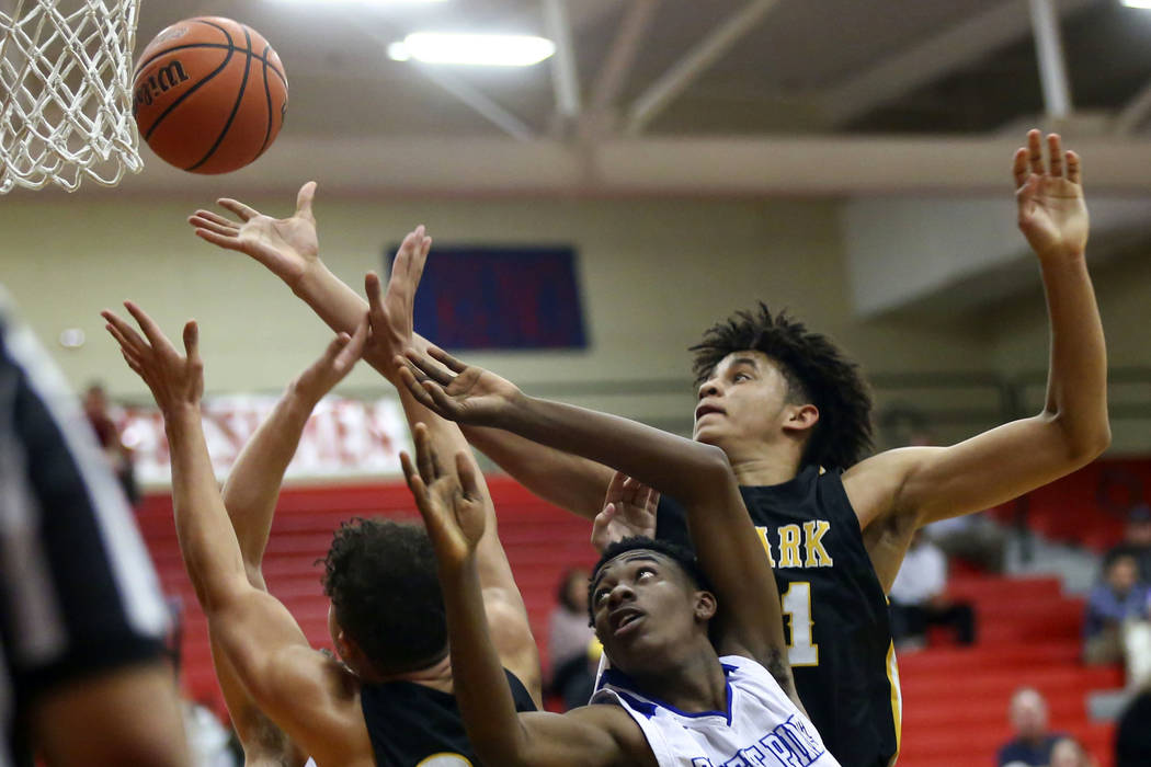 Clark's Jalen Hill, right, battles for a rebound against Desert Pines' Dayshawn Wiley (2) during the second half of a Class 4A state boys basketball quarterfinal game at Arbor View High School in ...