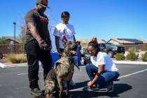 Veteran Dale Malone, left, his twin daughters Nahjae Malone, 17 and Nia Malone, 17 from Las Vegas stand with their new dog Onyx as the Nevada Department of Corrections partners with the "Thos ...