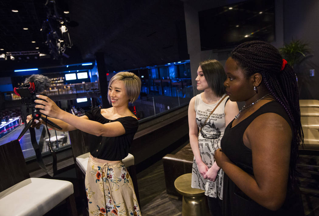 Cosplayer and influencer Stella Chuu, left, records video with grant recipients Giselle Colon, center, and Alesha DeBose while visiting the HyperX Esports Arena at the Luxor as part of the 1,000 D ...