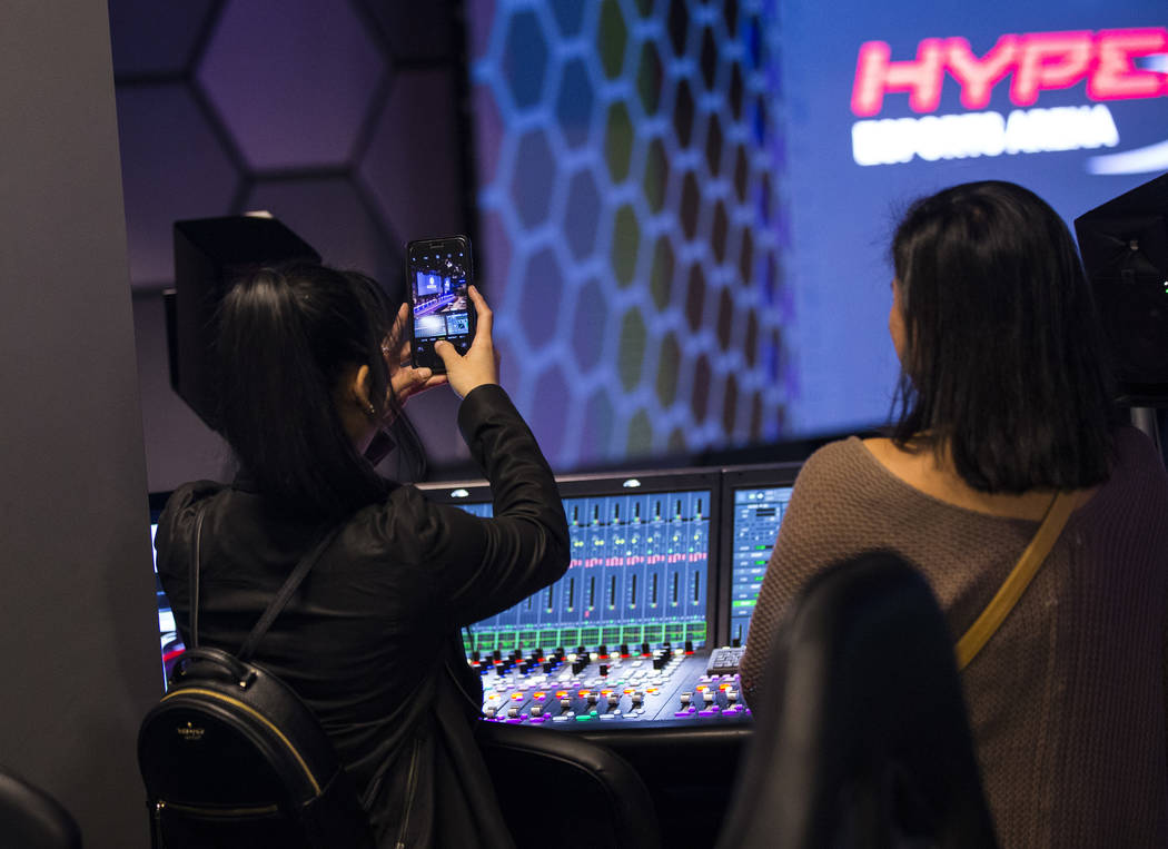 Grant recipient Obe Wan takes a picture while exploring the production room during a visit to the HyperX Esports Arena at the Luxor as part of the 1,000 Dreams Fund's BroadcastHER Academy Challeng ...