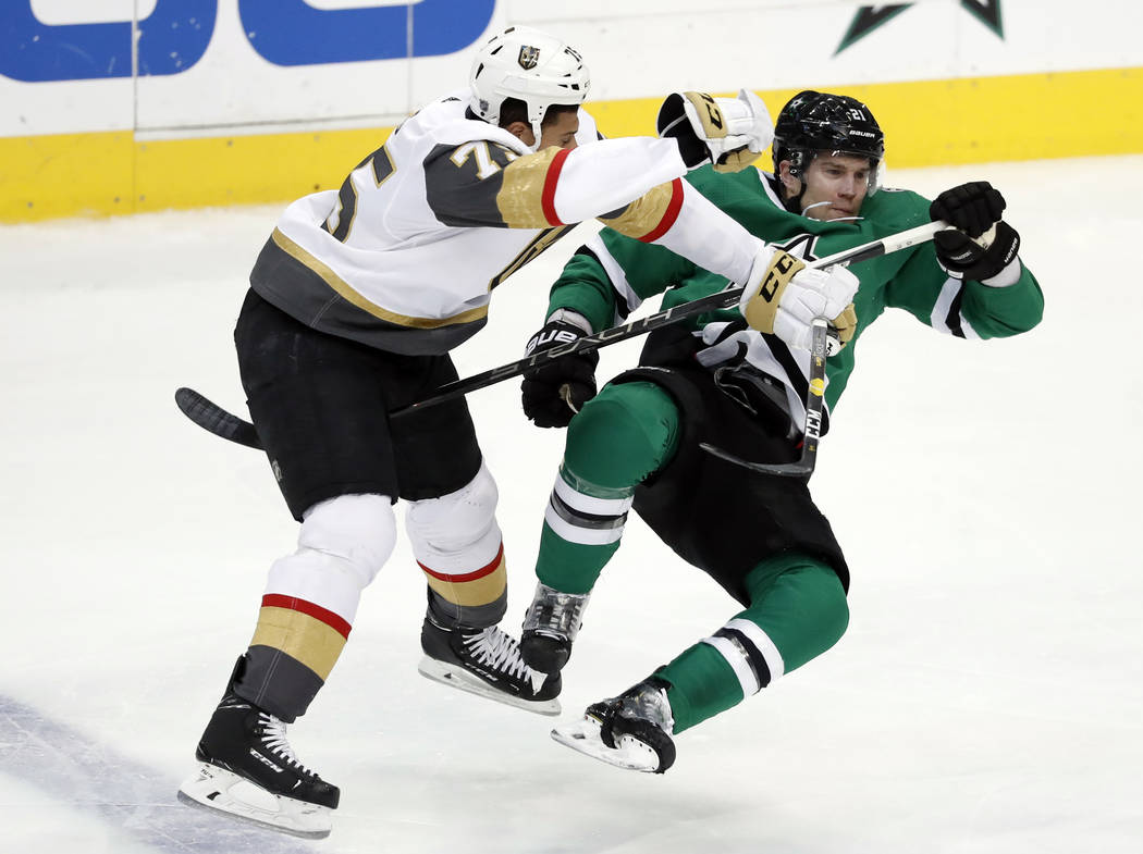 Vegas Golden Knights right wing Ryan Reaves (75) knocks Dallas Stars defenseman Ben Lovejoy (21) off his skates during a collision in the second period of an NHL hockey game in Dallas, Friday, Mar ...