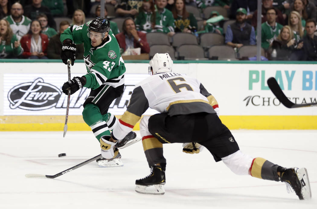 Dallas Stars right wing Valeri Nichushkin (43) takes a shot at the net as Vegas Golden Knights defenseman Colin Miller (6) helps defend in the first period of an NHL hockey game in Dallas, Friday, ...