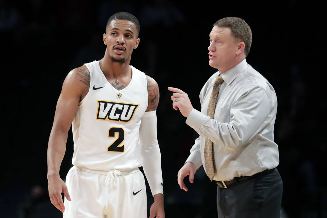Virginia Commonwealth head coach Mike Rhoades, right, talks to Marcus Evans (2) during the second half of an NCAA college basketball game in the Legends Classic tournament Monday, Nov. 19, 2018, i ...
