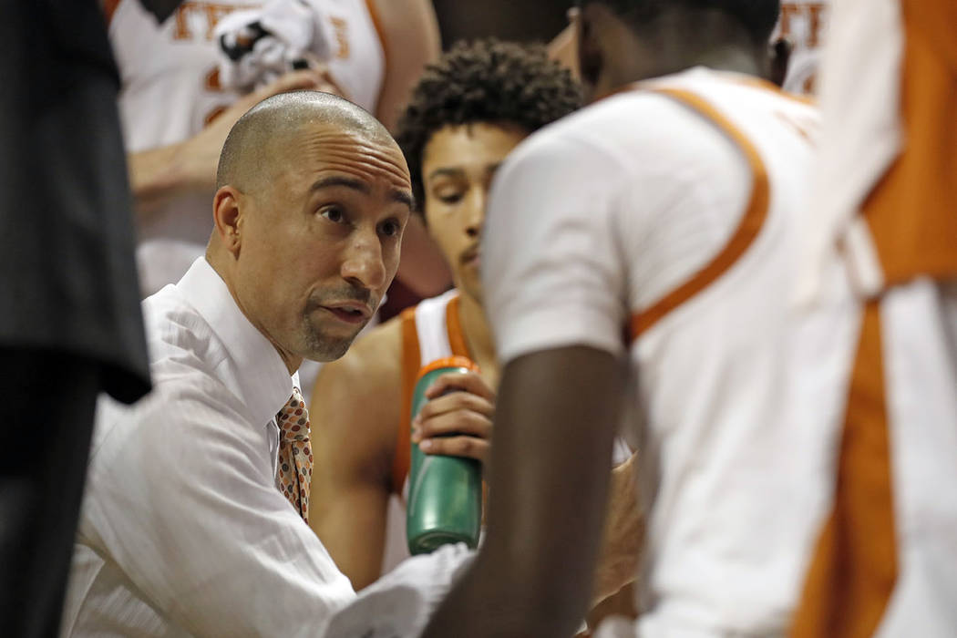 Texas coach Shaka Smart talks to his players on the bench during the first half of an NCAA college basketball game against Texas Tech, Monday, March 4, 2019, in Lubbock, Texas. (AP Photo/Brad Toll ...