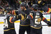 Golden Knights center Cody Eakin (21) celebrates his goal with teammates Oscar Lindberg (24) and Alex Tuch during the third period of an NHL hockey game against the Washington Capitals at T-Mobile ...