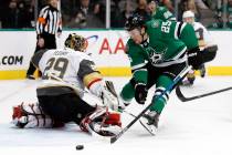 Vegas Golden Knights goaltender Marc-Andre Fleury (29) deflects a shot as Dallas Stars right wing Brett Ritchie (25) pressures the net in the first period of an NHL hockey game in Dallas, Friday, ...
