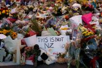 Mourners place flowers as they pay their respects at a makeshift memorial near the Masjid Al Noor mosque in Christchurch, New Zealand, Saturday, March 16, 2019. New Zealand's stricken residents re ...