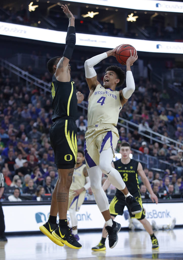 Washington's Matisse Thybulle shoots over Oregon's Kenny Wooten during the first half of an NCAA college basketball game in the final of the Pac-12 men's tournament Saturday, March 16, 2019, in La ...