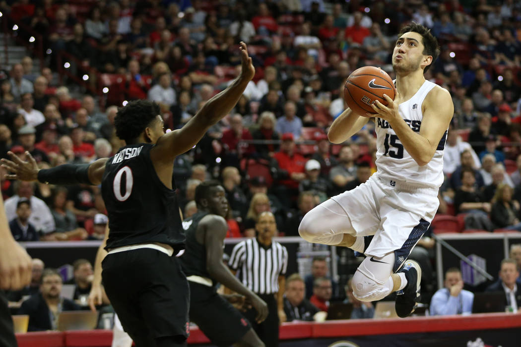 Utah State Aggies guard Abel Porter (15) goes up for a shot against San Diego State Aztecs guard Devin Watson (0) in the second half of the Mountain West tournament men's basketball championship g ...