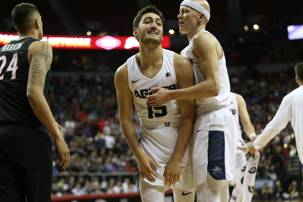 Utah State Aggies guard Abel Porter (15) with guard Brock Miller (22) reacts after a play against San Diego State Aztecs in the second half of the Mountain West tournament men's basketball champio ...