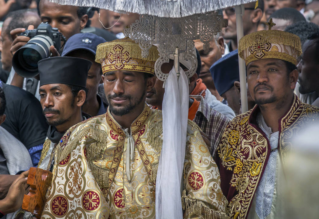 A priest cries at a mass funeral at the Holy Trinity Cathedral in Addis Ababa, Ethiopia Sunday, March 17, 2019. Thousands of Ethiopians have turned out to a mass funeral ceremony in the capital on ...