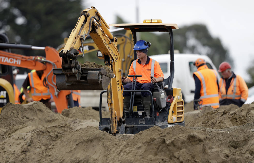 Workers prepare a Muslim cemetery following the Friday mass shootings at two mosques in Christchurch, New Zealand, Sunday, March 17, 2019. The live-streamed attack by an immigrant-hating white nat ...