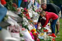 Mourners lay flowers on a wall at the Botanical Gardens in Christchurch, New Zealand, Saturday, March 16, 2019. New Zealand's stricken residents reached out to Muslims in their neighborhoods and a ...