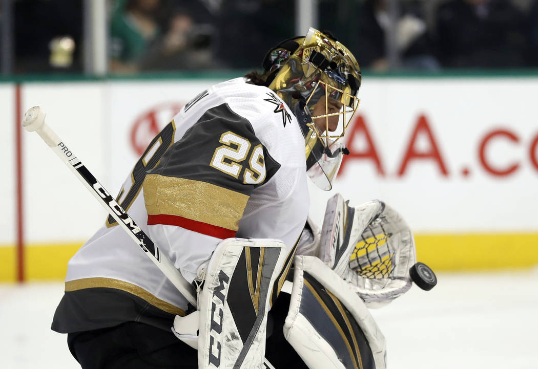 Vegas Golden Knights goaltender Marc-Andre Fleury (29) reaches out to glove a shot from the Dallas Stars in the first period of an NHL hockey game in Dallas, Friday, March 15, 2019. (AP Photo/Tony ...