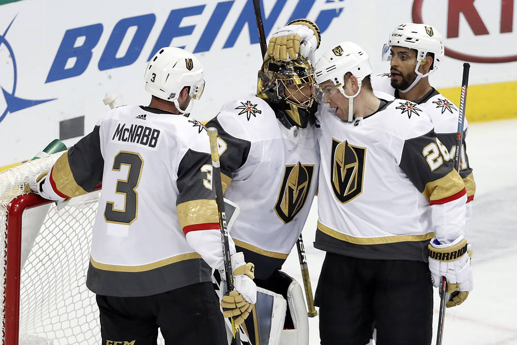 Vegas Golden Knights' Brayden McNabb (3), Paul Stastny (26) and Pierre-Edouard Bellemare, rear, celebrate with goalie Marc-Andre Fleury, second from left, after their 2-1 win against the Dallas St ...