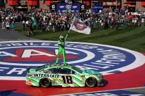 Kyle Buschs stands on his car after winning the NASCAR Cup Series race at Auto Club Speedway in Fontana, Calif., Sunday, March 17, 2019. (AP Photo/Rachel Luna)