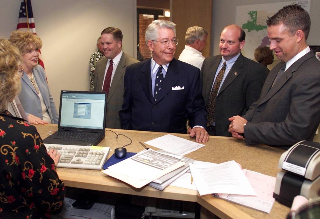 Richard Bunker, center, files as a candidate for Nevada State Senate district 9 at the Clark County Government Center Monday, May 20, 2002, flanked by supporters, from left, Judy Brailsford, John ...