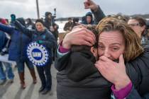Amy Drennen, right, of Lordstown, Ohio, an employee at General Motors for 12 years, receives a hug from Pam Clark, as people gather in front of the General Motors assembly plant, Wednesday, March ...