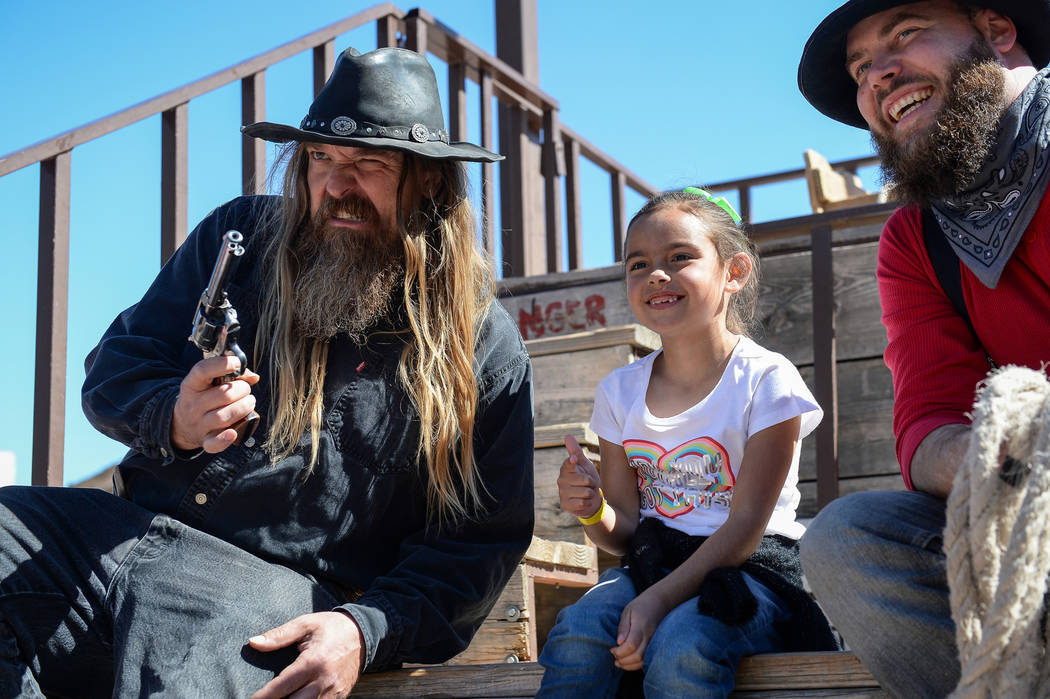 Ellie Mendoza, 7, from Las Vegas, center, poses for a photograph with Jesse Reeder, left, and Mike Kelly during the last day of operations at Bonnie Springs Ranch in Las Vegas, Sunday, March 17, 2 ...