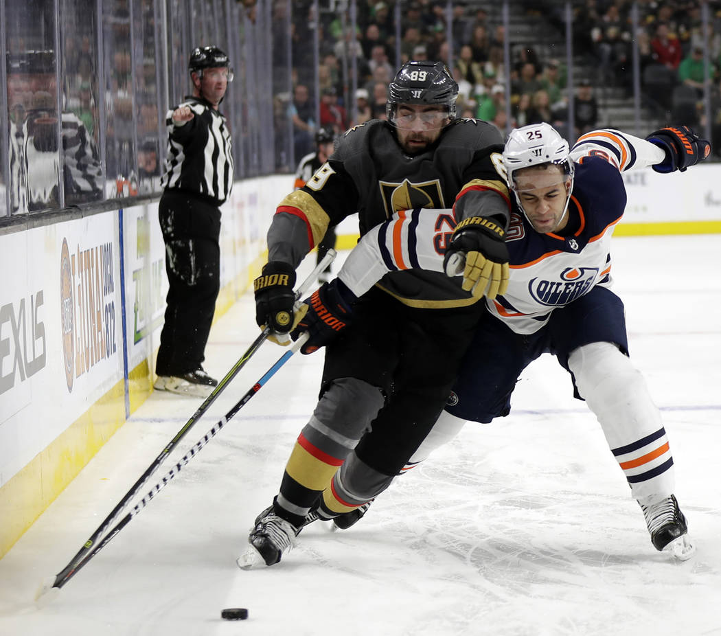 Vegas Golden Knights right wing Alex Tuch and Edmonton Oilers defenseman Darnell Nurse compete for control of the puck during the second period of an NHL hockey game Sunday, March 17, 2019, in Las ...