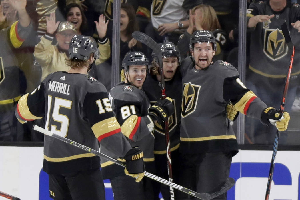 Vegas Golden Knights right wing Mark Stone, right, celebrates with teammates after scoring against the Edmonton Oilers during the first period of an NHL hockey game Sunday, March 17, 2019, in Las ...