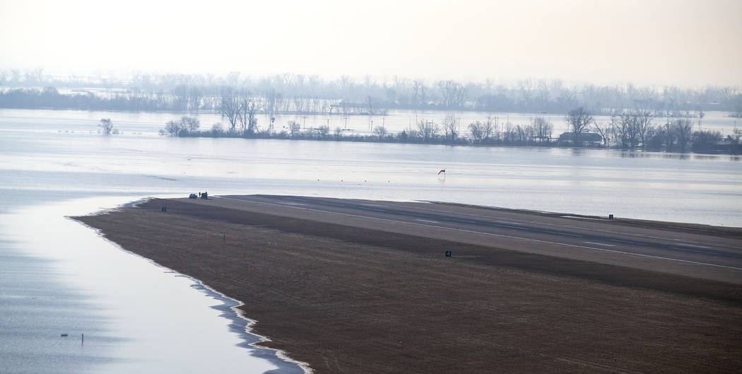 CORRECTS TO 2019 - Nearly 3,000 feet of Offutt Air Force Base's runway is covered by the flooding Missouri River Sunday, March 17, 2019, in Bellevue, Neb. Hundreds of people were evacuated from th ...