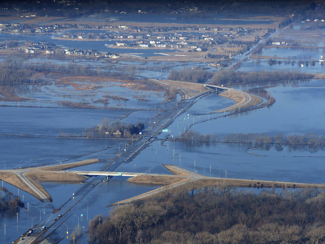 CORRECTS MONTH TO MARCH NOT MAY - The Elkhorn River consumes a section of western Douglas County Sunday, March 17, 2019, in Omaha, Neb. Hundreds of people were evacuated from their homes in Nebras ...