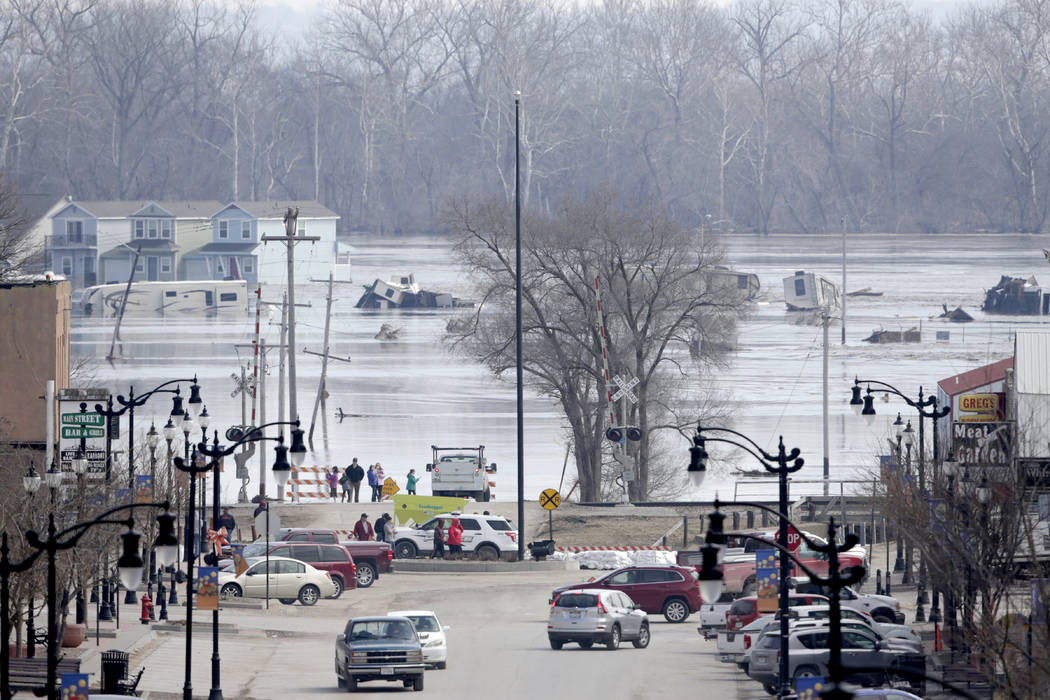People view the rising waters from the Platte and Missouri rivers which flooded areas of Plattsmouth, Neb., Sunday, March 17, 2019. Hundreds of people remained out of their homes in Nebraska, but ...