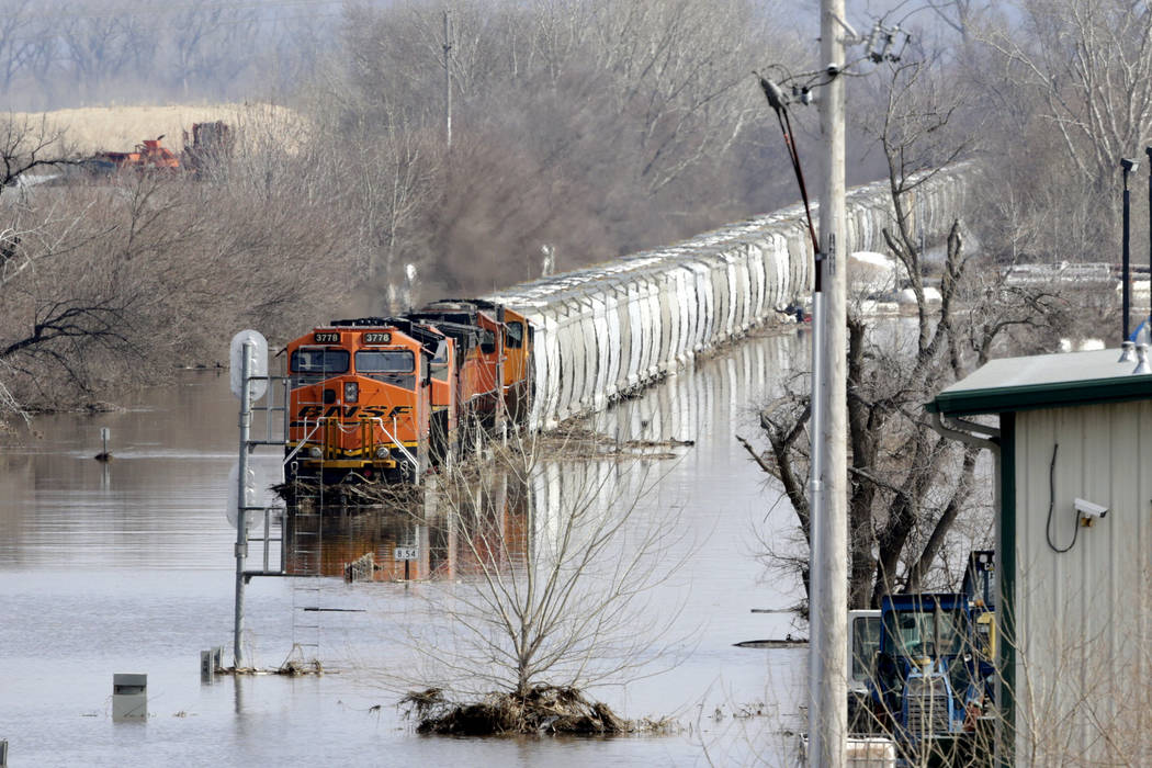 A BNSF train sits in flood waters from the Platte River, in Plattsmouth, Neb., Sunday, March 17, 2019. Hundreds of people remained out of their homes in Nebraska, but rivers there were starting to ...
