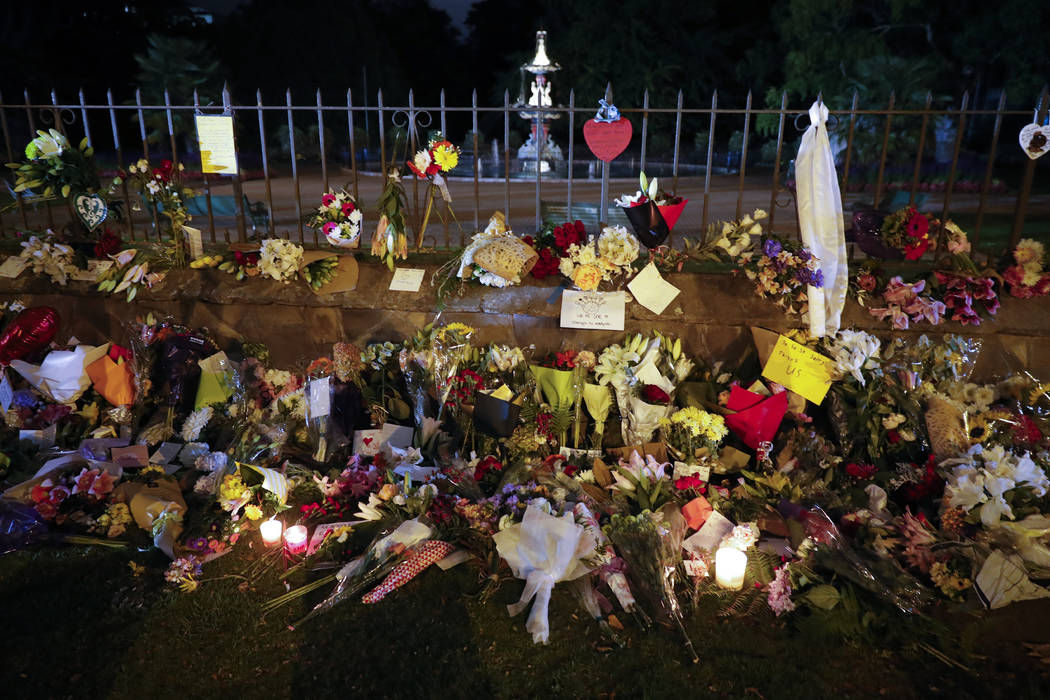 Mourners place flowers as they pay their respects at a makeshift memorial near the Masjid Al Noor mosque in Christchurch, New Zealand,, Saturday, March 16, 2019. New Zealand's stricken residents r ...