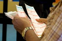 A man looks over his numbers on his Powerball tickets at the Primm Valley Lotto Store, Wednesday, Aug. 16, 2017. Elizabeth Brumley Las Vegas Review-Journal