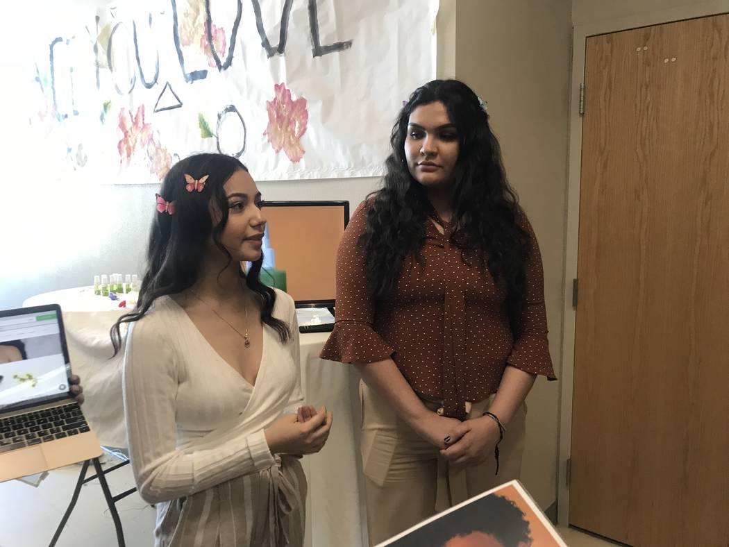 Samari Badraza (left) and Bryanna Grijalva, talk to guests about their company Serenity. The group created lip scrubs, lip glosses, and hydrating sprays by researching the benefits for various sk ...
