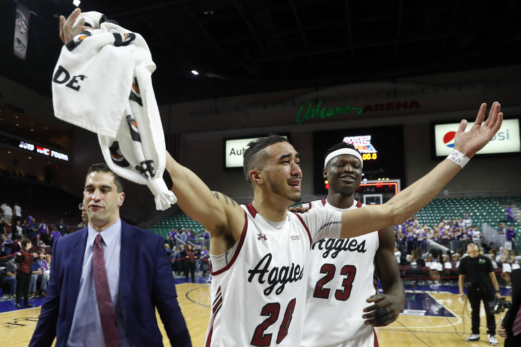New Mexico State guard Trevelin Queen (20) and forward Mohamed Thiam (23) celebrate the team's 89-57 win over Grand Canyon in an NCAA college basketball game for the Western Athletic Conference me ...