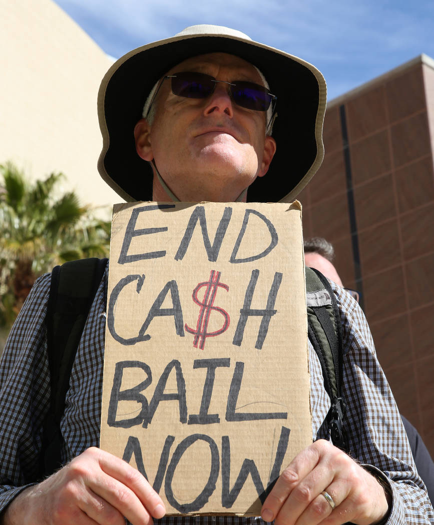 William O'Connell holds a sign outside of the Grant Sawyer Building as he protests to promote criminal justice reform on Monday, March 18, 2019, in Las Vegas. Bizuayehu Tesfaye Las Vegas Review-Jo ...