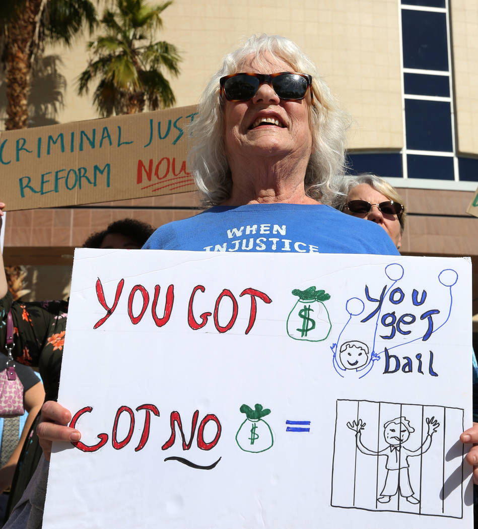 Gayanne Fried holds a sign outside of the Grant Sawyer Building as she protests to promote criminal justice reform on Monday, March 18, 2019, in Las Vegas. Bizuayehu Tesfaye Las Vegas Review-Journ ...