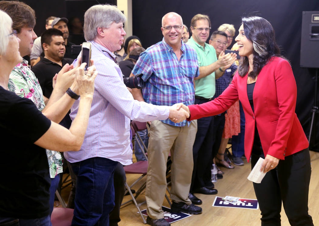 Presidential hopeful U.S. Rep. Tulsi Gabbard, D-Hawaii, says hello to supporters, including Reilly Stephen, during a meet and greet at the Asian Culture Center in downtown Las Vegas Monday, March ...