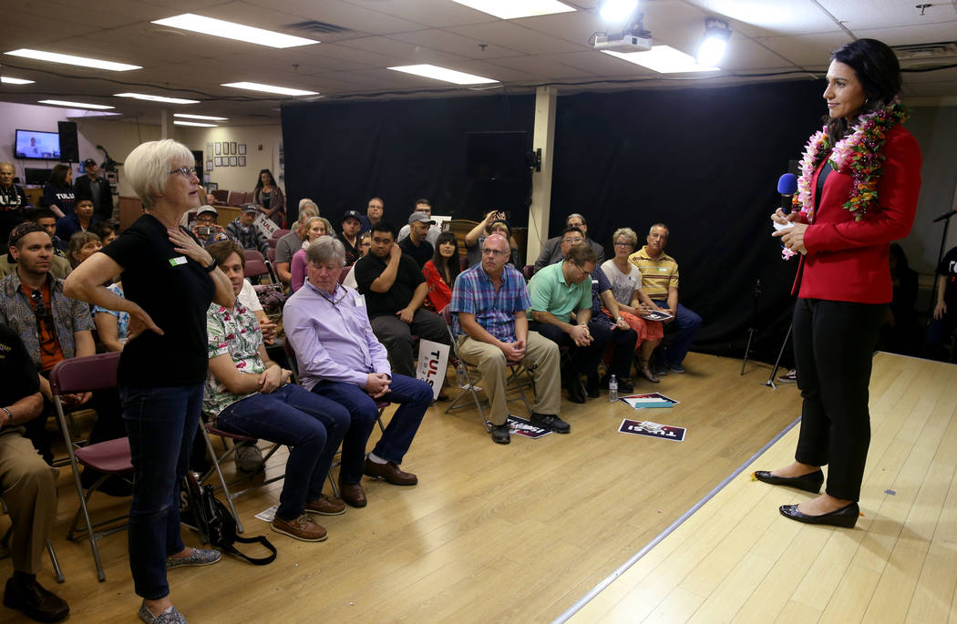 Presidential hopeful U.S. Rep. Tulsi Gabbard, D-Hawaii, right, takes a questions from Mary Macioce, standing left, during a meet and greet at the Asian Culture Center in downtown Las Vegas Monday, ...