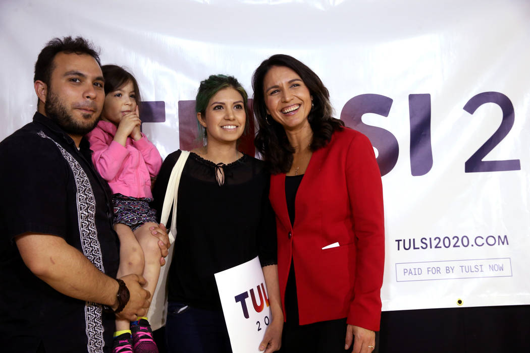 Presidential hopeful U.S. Rep. Tulsi Gabbard, D-Hawaii, right, with Joshio Herrera, his daughter Winter Herrera, 4, and her mother Vanessa Gomez, of Las Vegas during a meet and greet at the Asian ...